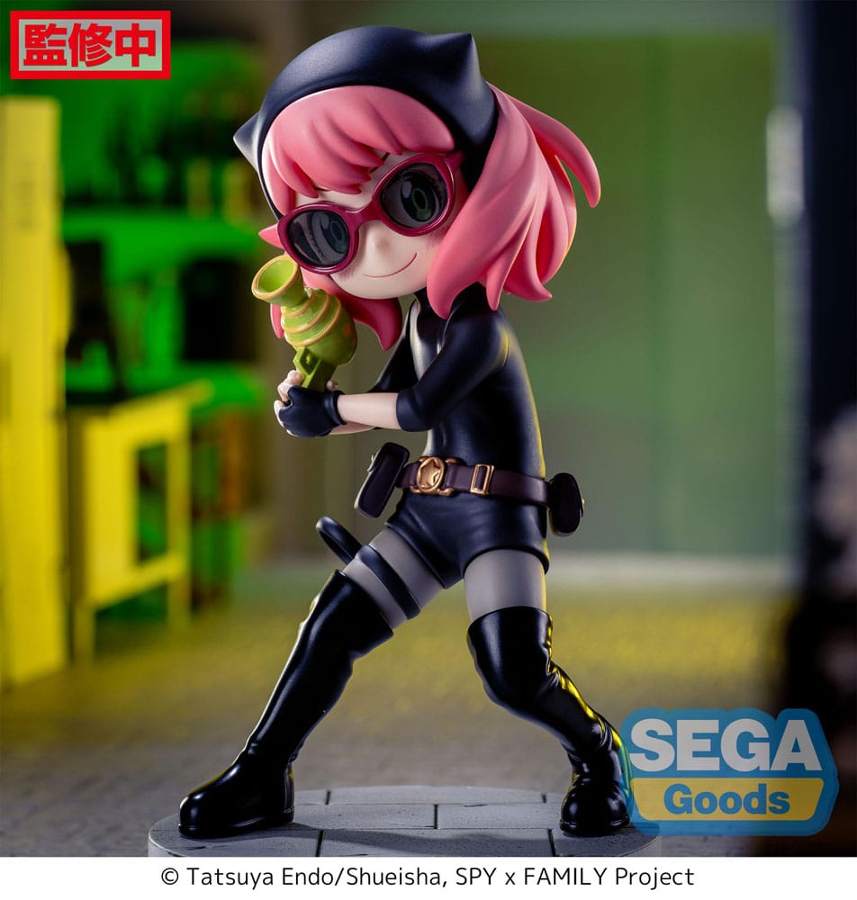 Figurine d’Anya Forger en tenue d’espionne noire avec lunettes, bottes et ceinture, tenant un pistolet-jouet vert, debout sur un socle pavé. Inspirée de la série Spy x Family.