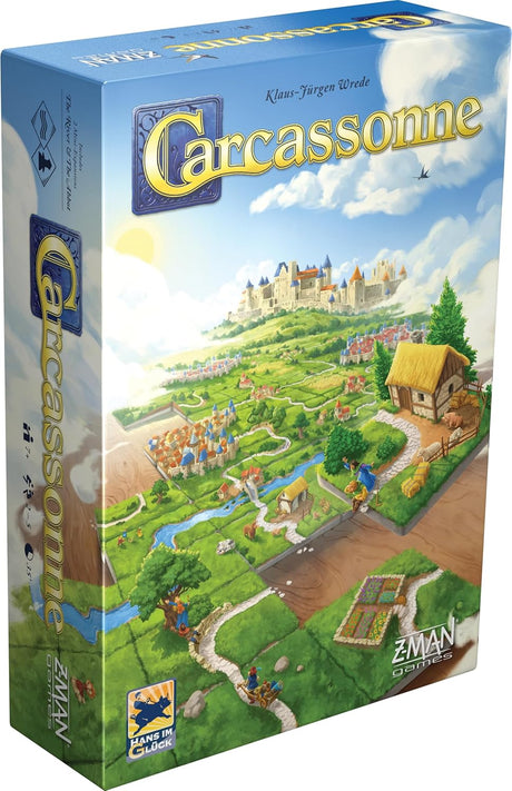 Boîte du jeu Carcassonne avec paysage médiéval, cité fortifiée, routes, champs et tuiles en cours de placement.