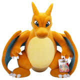 Grande peluche Pokémon Dracaufeu 60 cm orange avec ventre beige, ailes bleutées, griffes blanches et étiquette Pokémon.