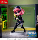 Figurine d’Anya Forger en tenue d’espionne noire avec lunettes, bottes et ceinture, tenant un pistolet-jouet vert, debout sur un socle pavé. Inspirée de la série Spy x Family.