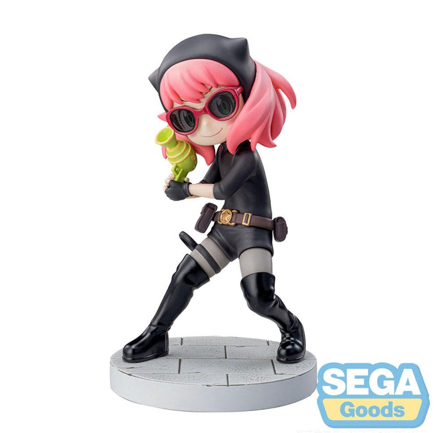 Figurine d’Anya Forger en tenue d’espionne noire avec lunettes, bottes et ceinture, tenant un pistolet-jouet vert, debout sur un socle pavé. Inspirée de la série Spy x Family.
