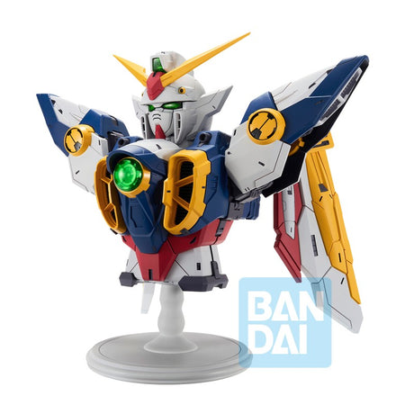 Figurine Bandai Ichibansho Wing Gundam 30th Anniversary sur socle, avec armure blanche, bleue, rouge et jaune et ailes mécaniques.